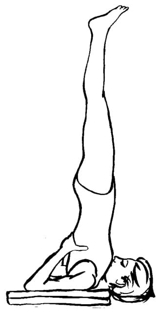 Line drawing of a woman doing shoulder stand on blankets.