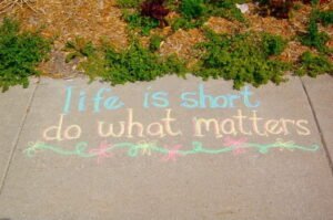 Chalk writing on the sidewalk: life is short, do what matters