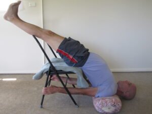 Daniel in chair shoulderstand supported yoga pose