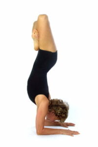 Image of a yoga teacher in an advanced upside down pose
