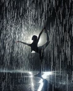 image of a woman doing a standing yoga pose in pouring rain