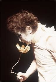 Kazuo_Ohno, founder of Butoh dance, as an old man smelling a flower.